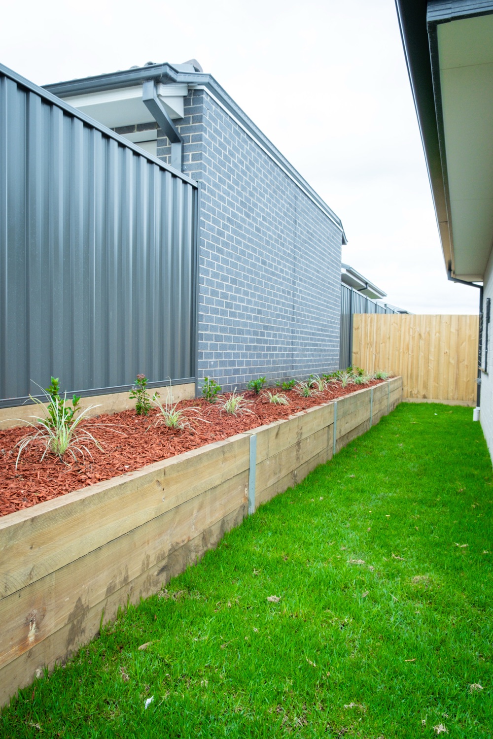 Completed Colorbond fence with landscaped lawn