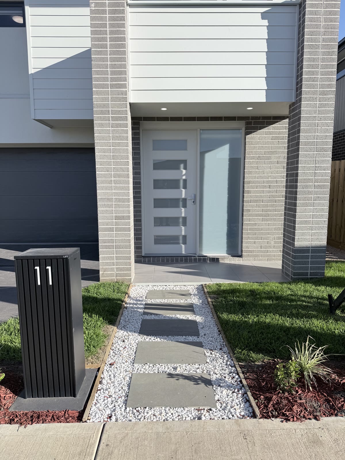 Block retaining wall with a paved entrance path